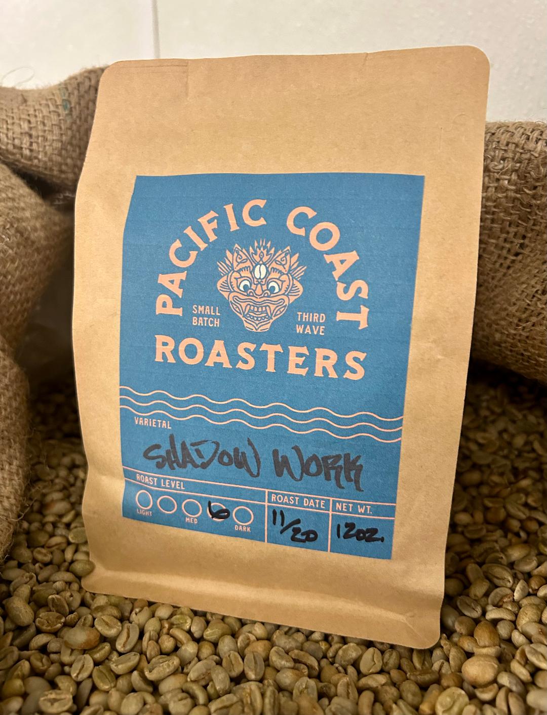 Coffee bag from Pacific Coast Roasters on a bed of coffee beans