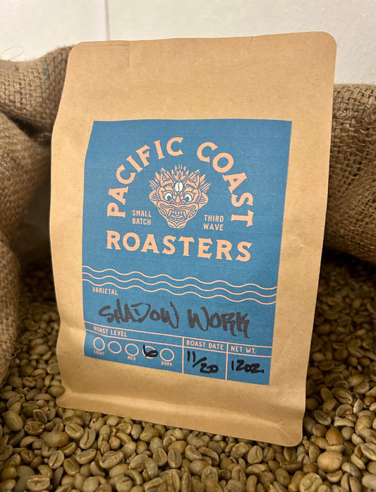 Coffee bag from Pacific Coast Roasters on a bed of coffee beans