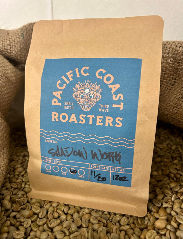 Coffee bag from Pacific Coast Roasters on a bed of coffee beans